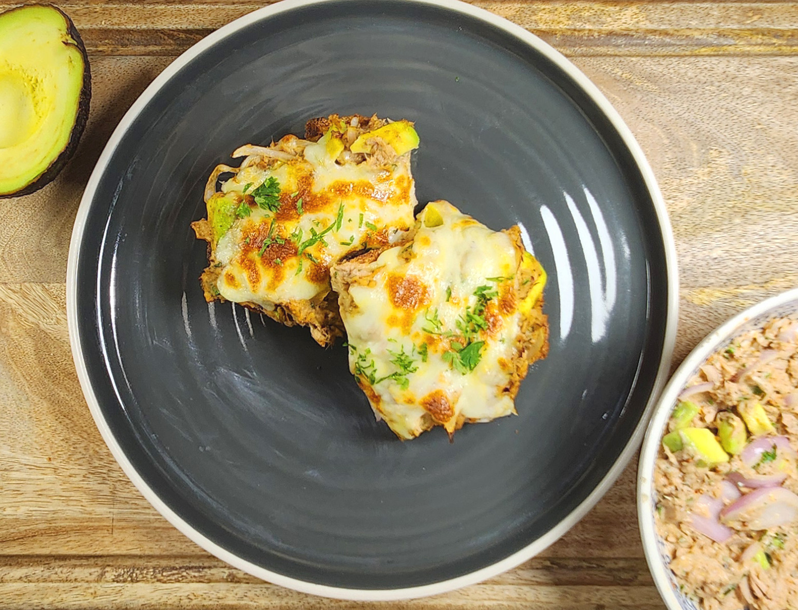 tuna melt on toast with cut avocado and tuna mix